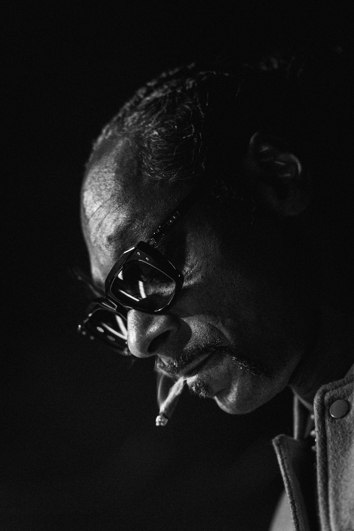 Black and white portrait of a performer in sunglasses