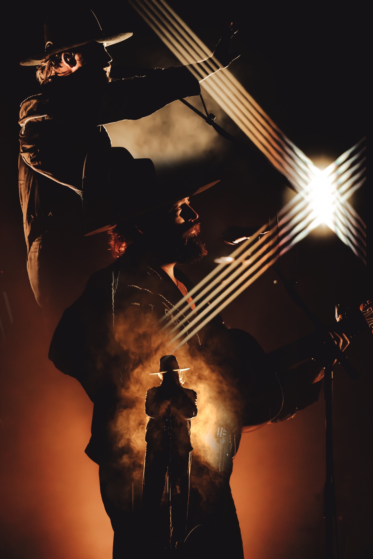 Performer silhouetted against golden backlight