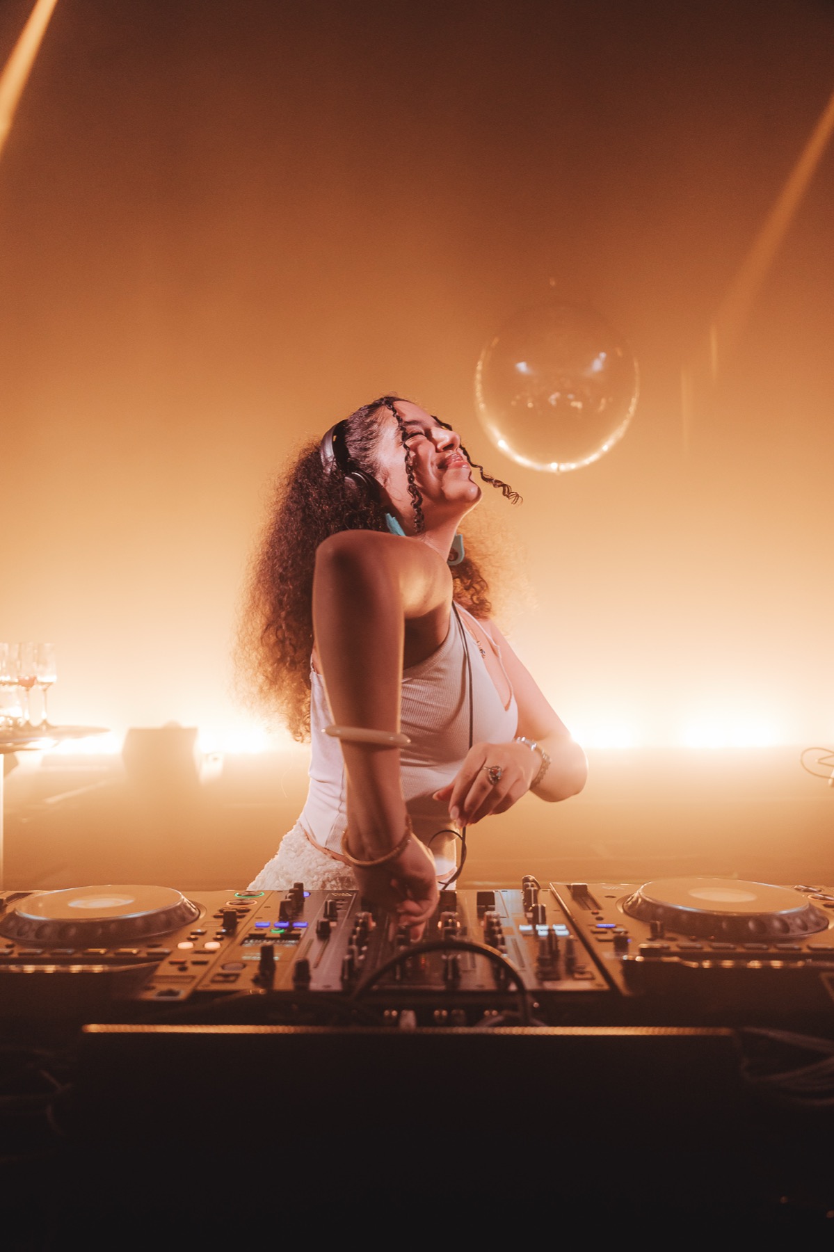 DJ performing in warm stage light