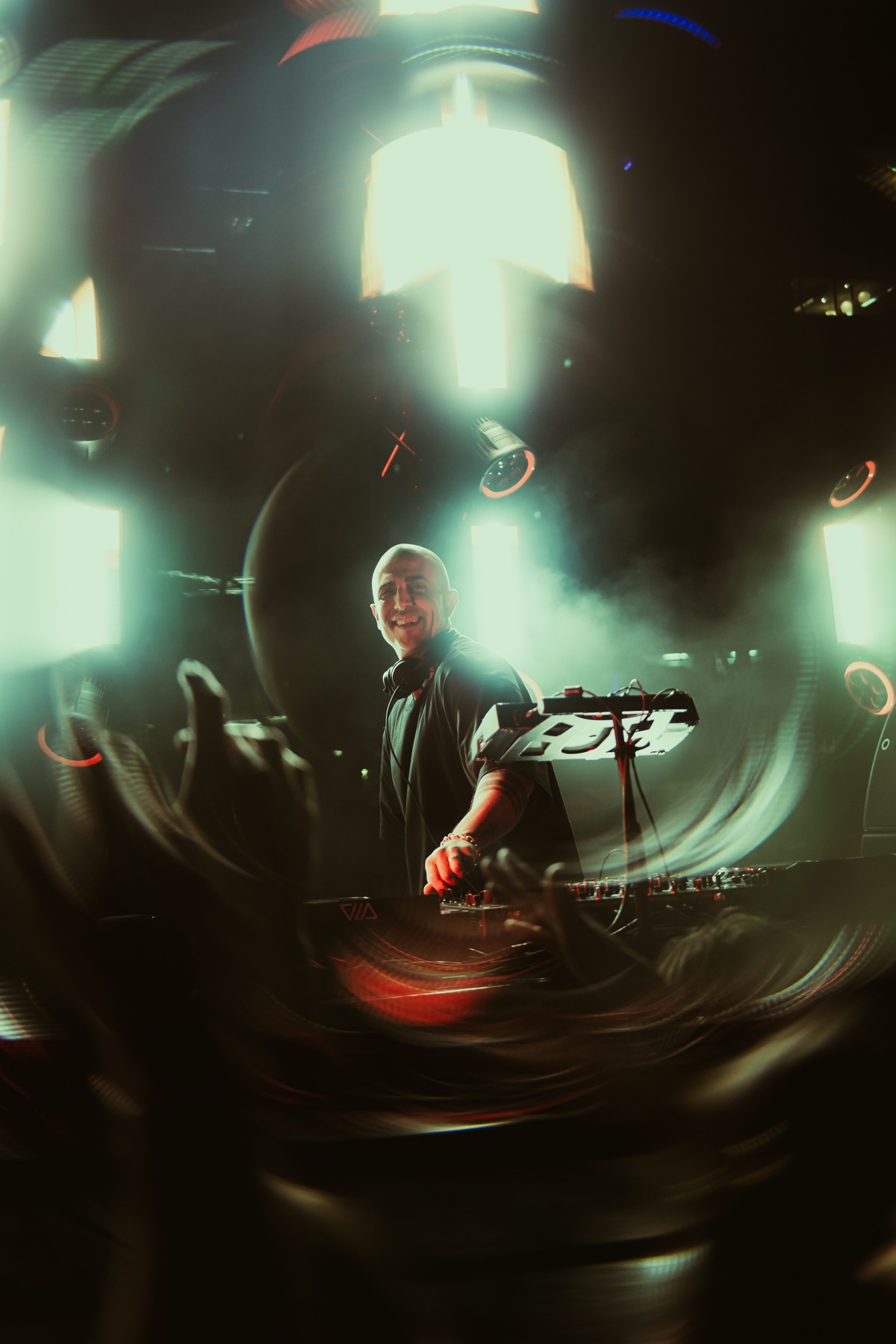Motion-blurred DJ set in low light