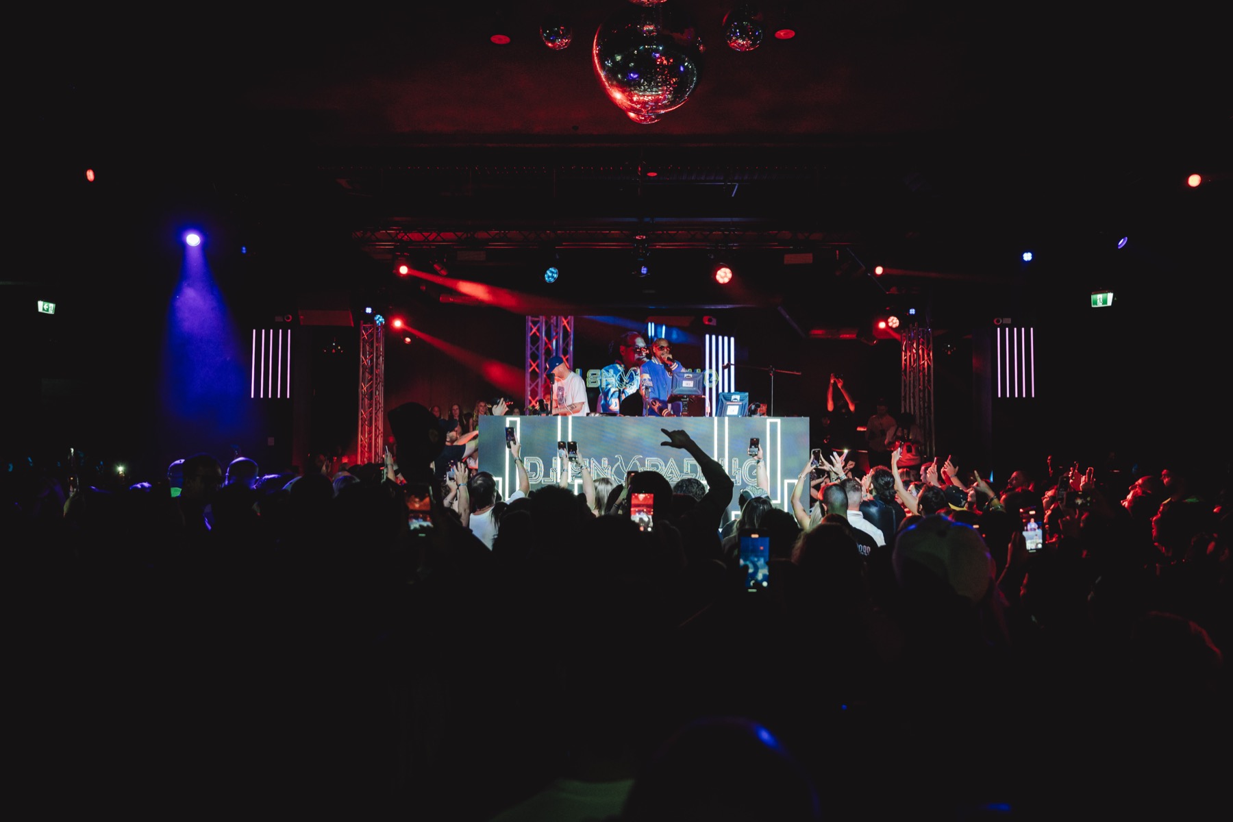 Wide view of a lit stage from the venue floor