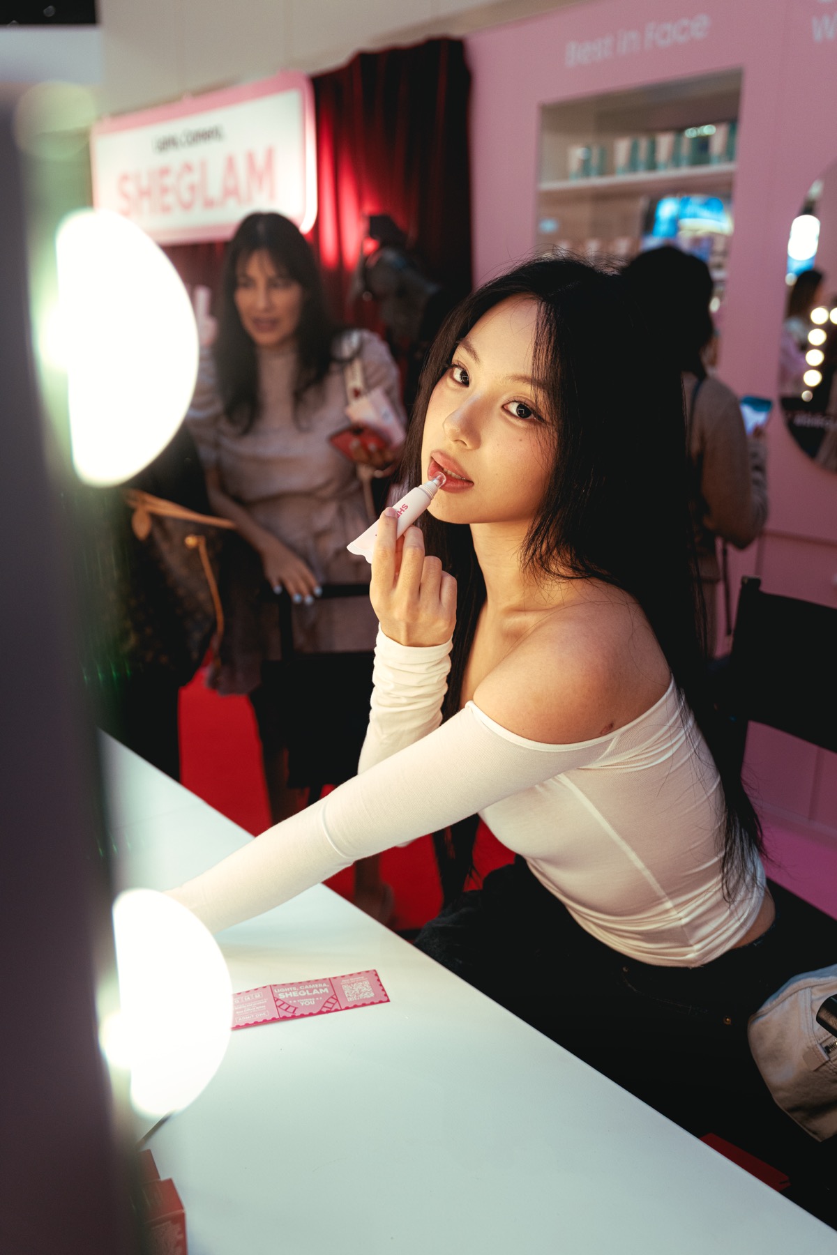 Guest at the mirror during a Sheglam beauty brand activation