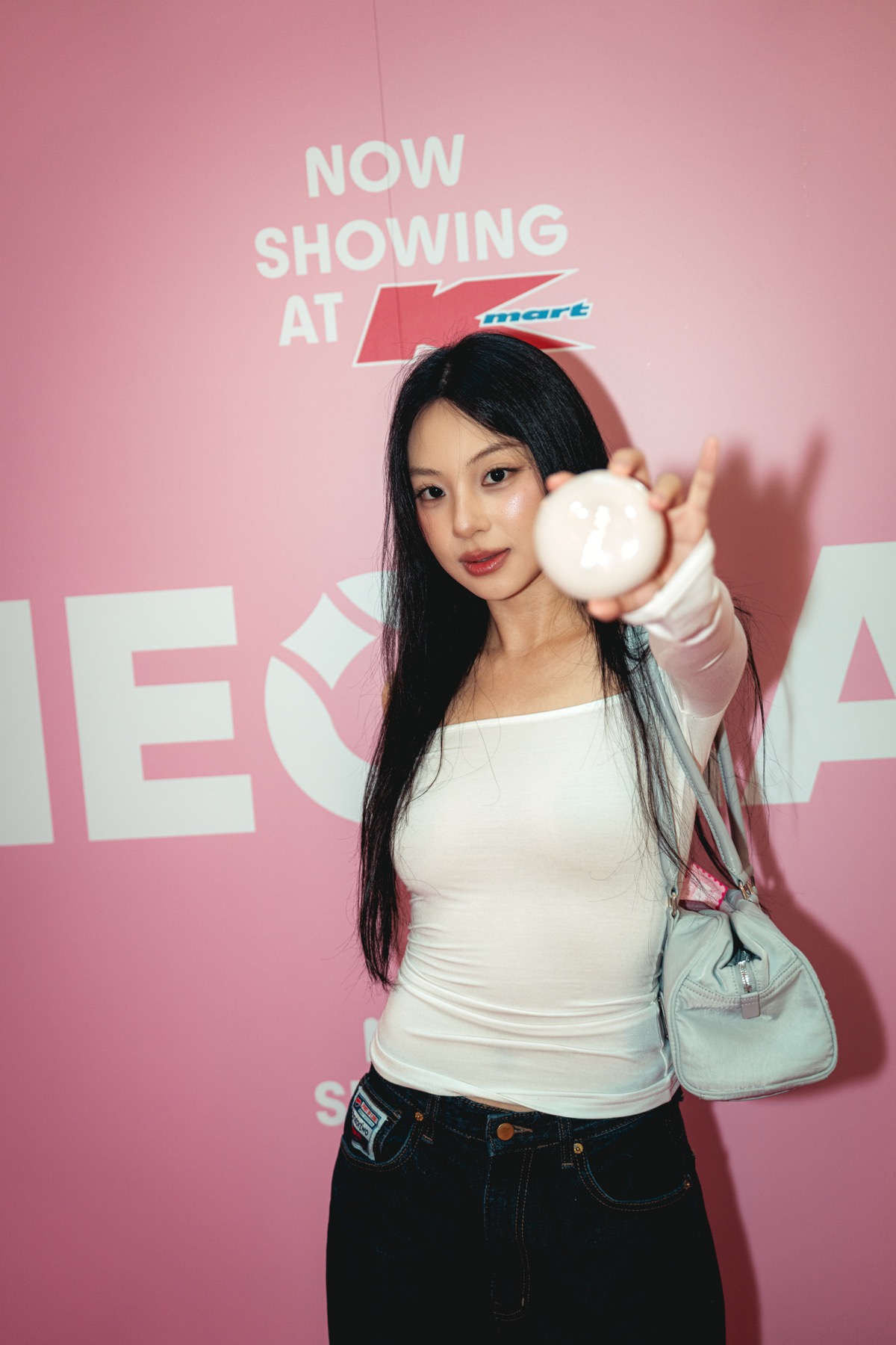 Guest with product at the Sheglam media wall