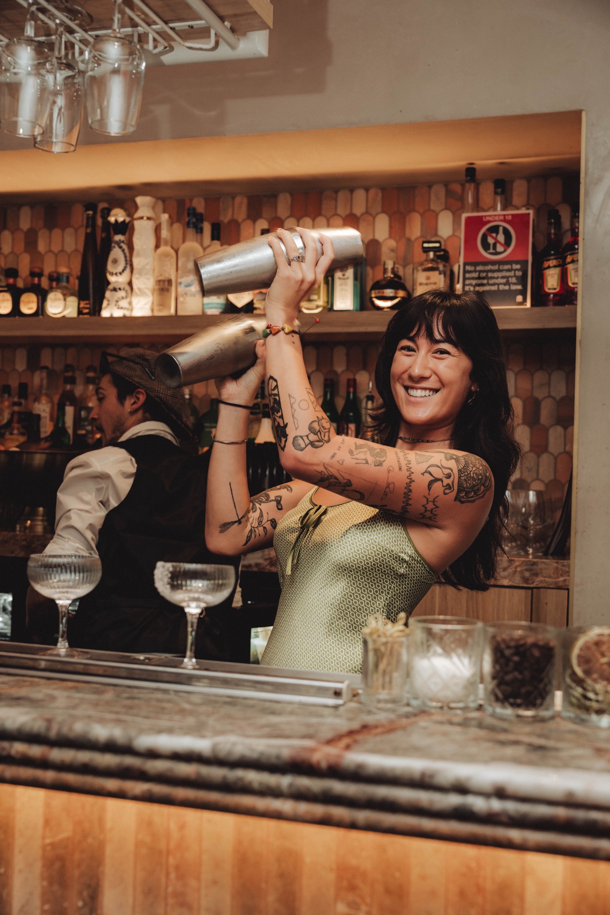 Bartender shaking cocktails behind the bar