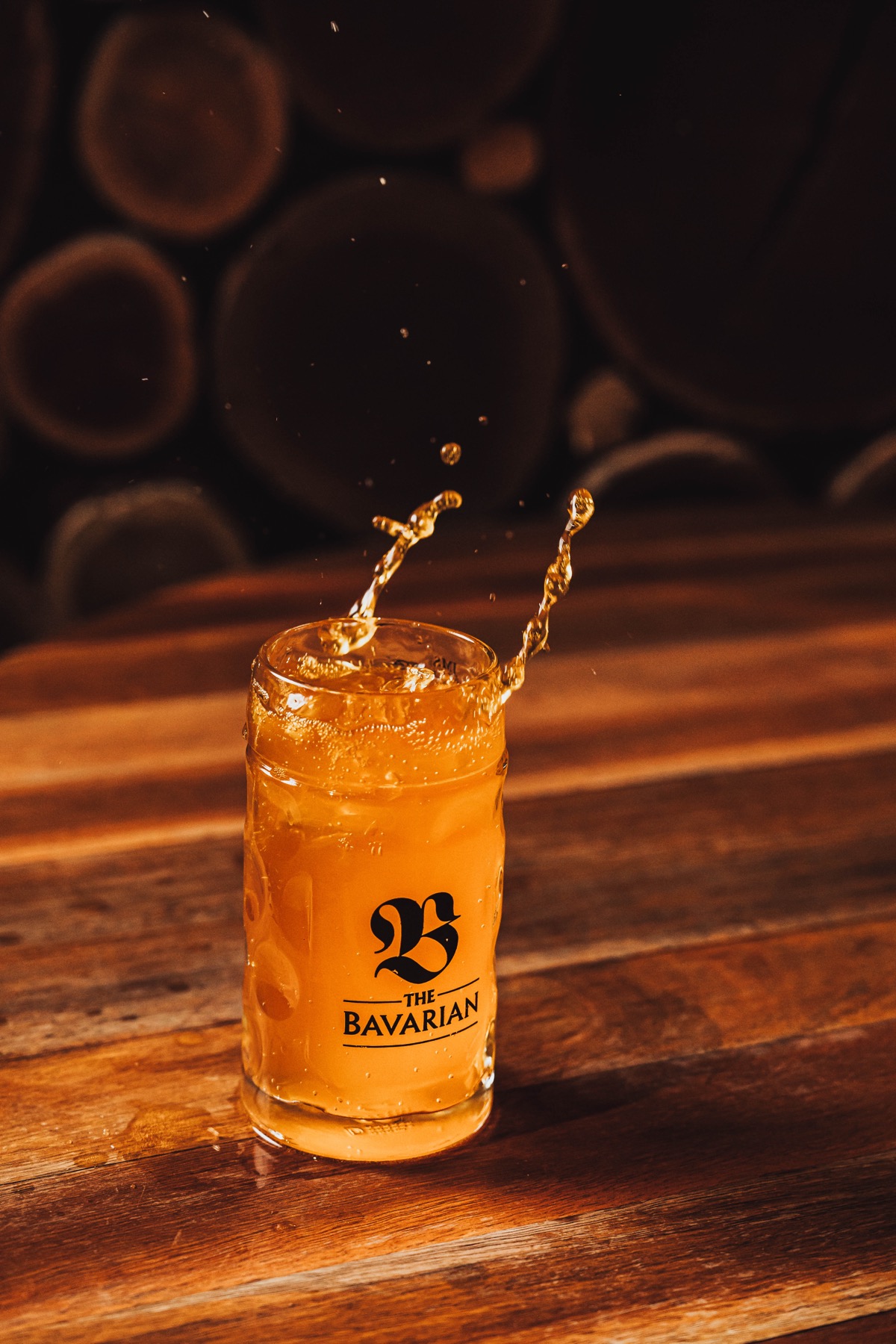 Beer splashing in a Bavarian-branded glass