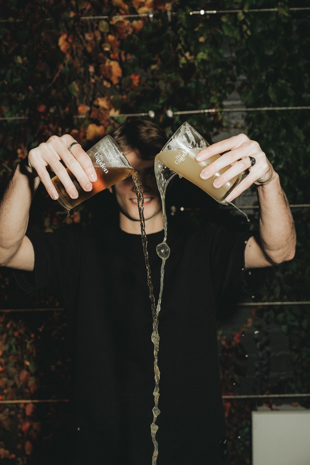Bartender pouring two cocktails simultaneously