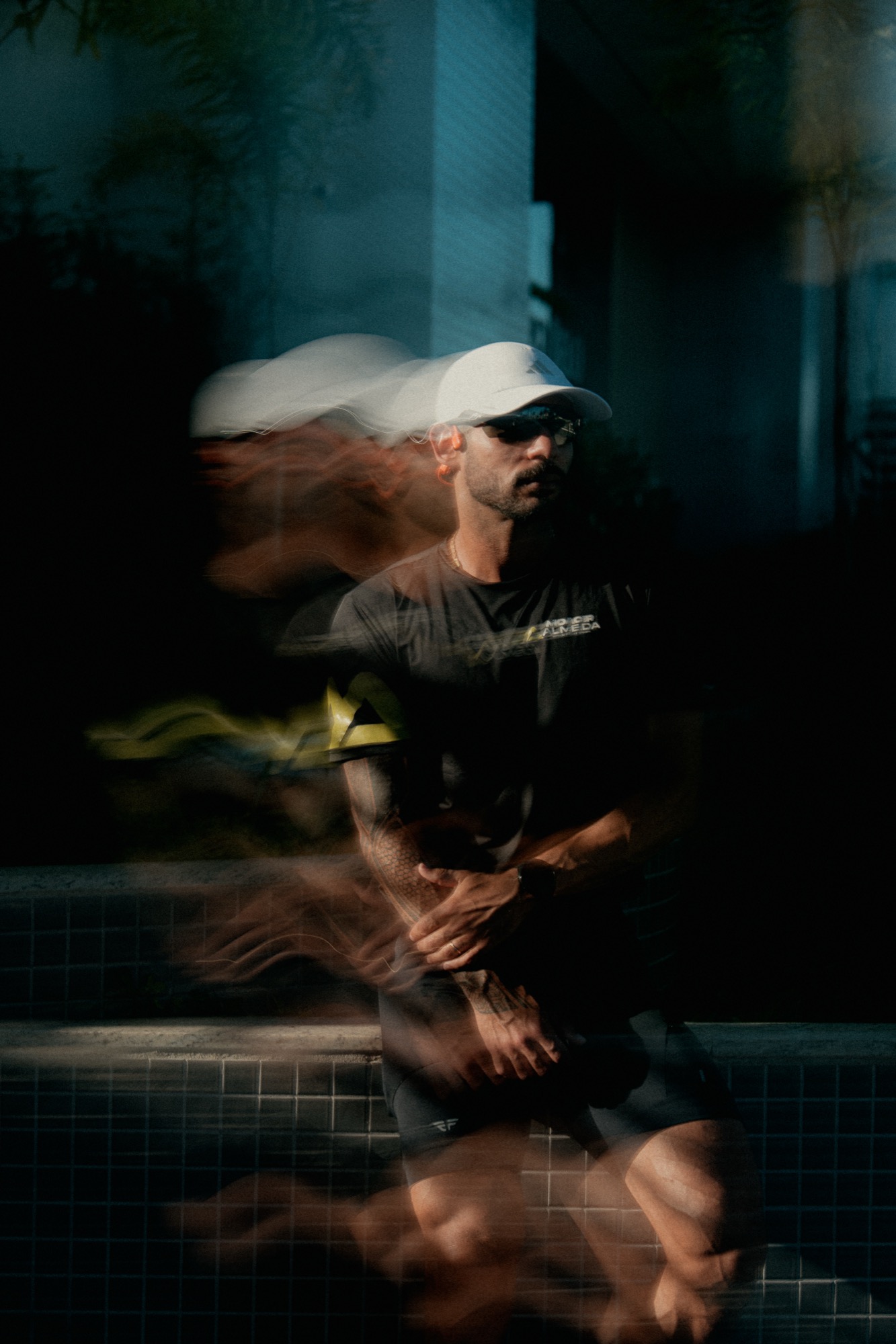 Motion-blur portrait of an artist in a cap at a night event in Sydney